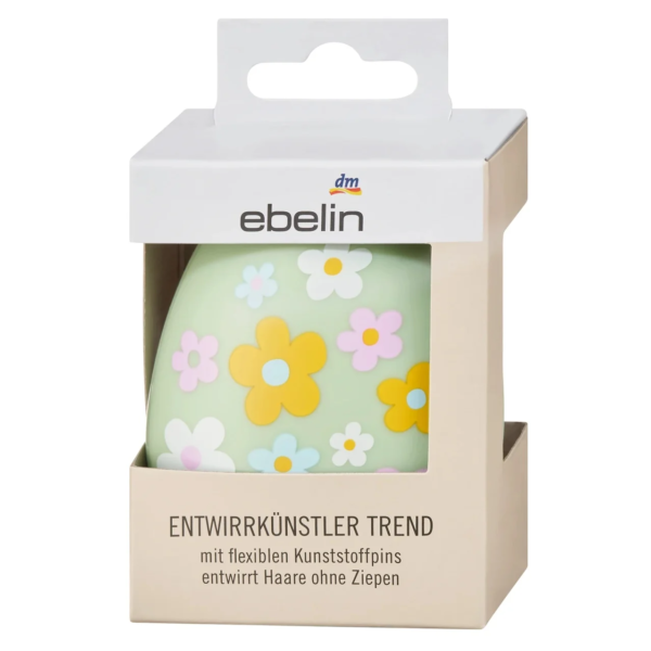 Une mini brosse pour cheveux Ebelin, 1 pièce, dotée d'une base vert pastel ornée de motifs floraux colorés et de poils en plastique flexibles.