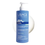 Flacon bleu de 500 ml d'URIAGE BÉBÉ 1ER LINIMENT OLÉOTHERMAL avec pompe blanche.