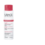 Flacon de URIAGE Roseliane Fluide Dermo Nettoyant 250 ml au bouchon rose et texte en français et anglais, idéal pour les soins des peaux sensibles. Le URIAGE Roseliane Fluide Dermo Nettoyant est parfait pour les routines de nettoyage en douceur.