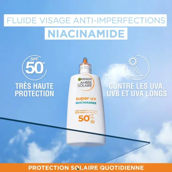 Un flacon de crème solaire Garnier Fluide Solaire SPF50 Anti Imperfections Super UV 40 ml est photographié sur un fond de ciel bleu avec un texte protecteur. dakar, Sénégal