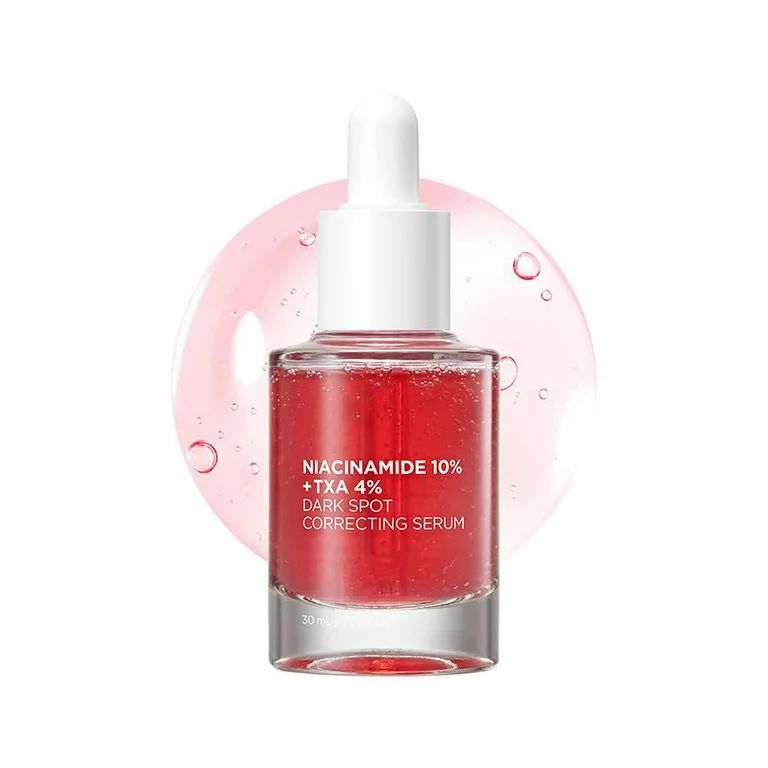 Un flacon compte-gouttes étiqueté « Anua Niacinamide 10% + TXA 4% Sérum Correcteur Tâches Hyperpigmentation 30 ml » avec un liquide rose à l'intérieur