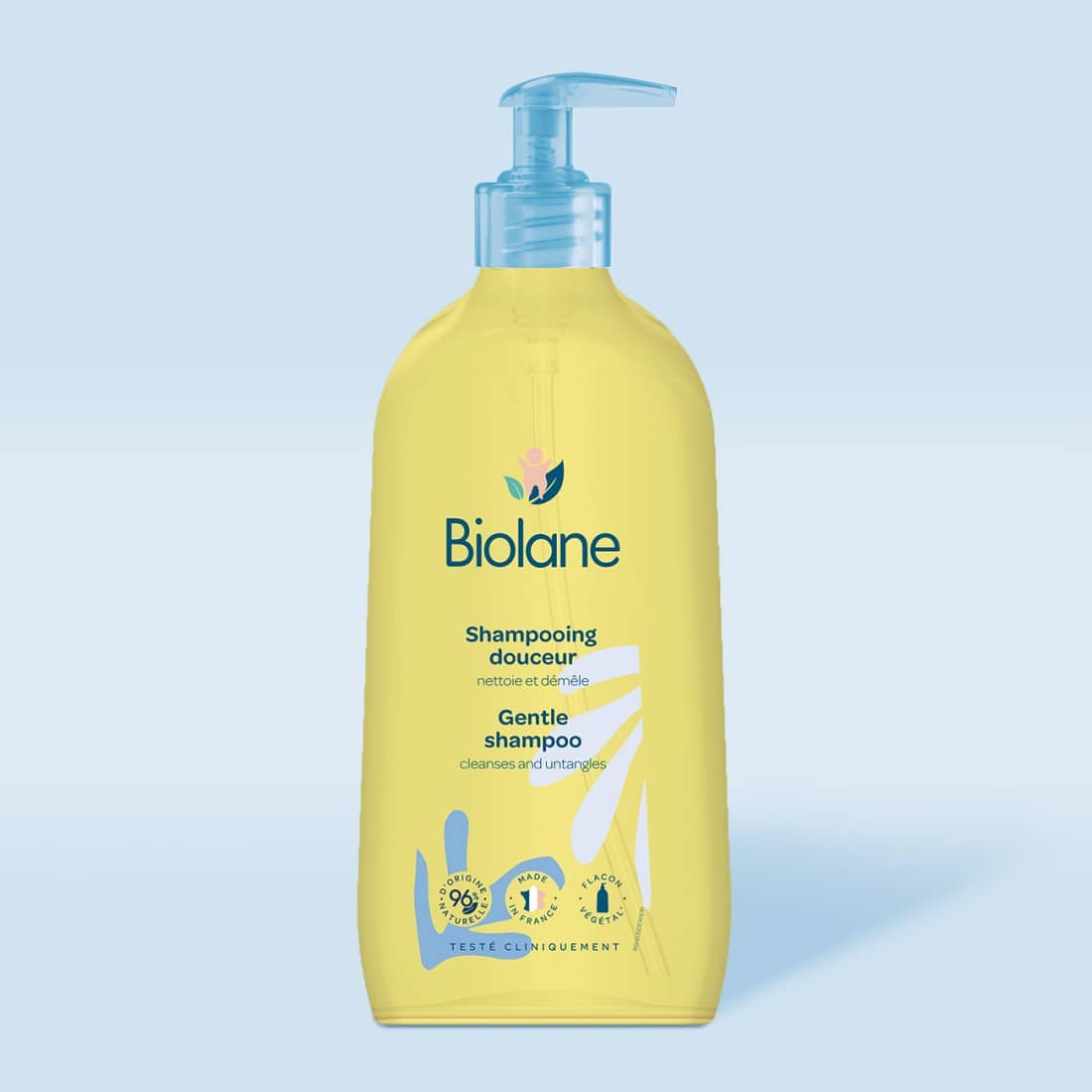 Un flacon de Biolane – Shampoing Douceur 350 ml avec distributeur à pompe sur fond bleu clair