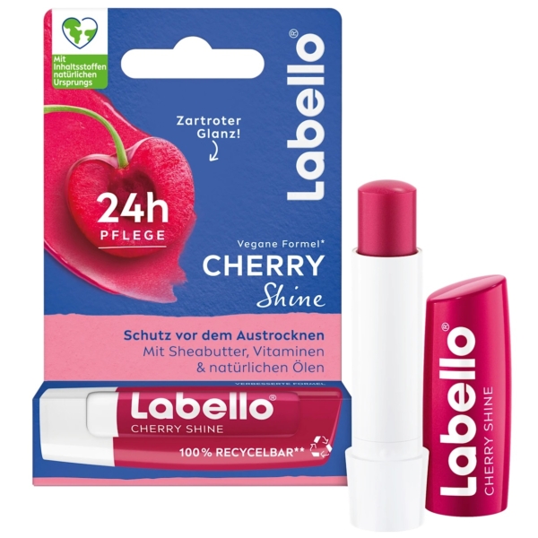 Le baume à lèvres Labello Cherry Shine, appelé Labello Cherry Shine Baume à Lèvres Hydratant Fraise 4,8 g, est présenté dans un tube rouge vif avec un baume visible. Il met en valeur « 24h Pflege », une formule vegan, du beurre de karité nourrissant et des vitamines, et arbore un motif cerise qui reflète son attrait fruité. Dakar