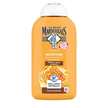 Flacon orange du shampoing Le Petit Marseillais Nutrition, avec une étiquette au miel et au beurre de karité bio. Le flacon est muni d'un bouchon à pression et est annoncé sans silicone, conçu pour les cheveux secs et cassants. L'étiquette présente les informations et les logos du produit. Dakar