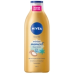 Cette édition limitée de 400 ml Nivea Lait Corporel Winter Moments Beurre de Karité présente un bouchon bleu, une étiquette dorée et un texte mettant en valeur « Winter Edition » et « 72h Feuchtigkeit », orné d'une icône de noix de coco et de flocon de neige. Dakar