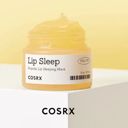 Un pot de masque de nuit pour les lèvres COSRX Lip Sleep Propolis, étiqueté « Full Fit », à la texture jaune crémeuse. Le pot est posé sur une surface blanche, avec le nom de la marque COSRX inscrit en dessous. Dakar